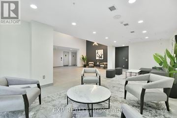 Ottawa apartment for rent - A modern living room with grey furniture and a marble table.