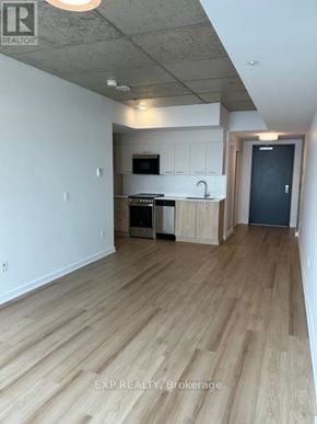 Ottawa apartment for rent - A kitchen with wooden floors and white walls.