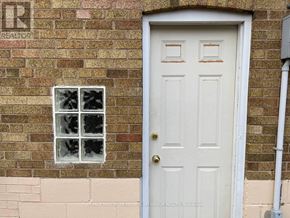 Toronto (Lansing-Westgate) apartment for rent - A white door with a window above it on a brick wall.