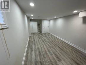 Toronto (Lansing-Westgate) apartment for rent - A room with wooden flooring and white walls.
