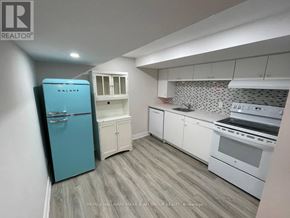 Toronto (Lansing-Westgate) apartment for rent - A kitchen with a blue fridge and white cabinets.