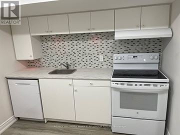 Toronto (Lansing-Westgate) apartment for rent - A white kitchen with a Brokerage stove top oven.