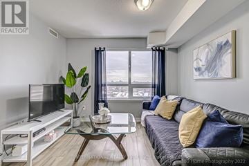 Toronto (Dovercourt-Wallace Emerson-Junction) condo for rent - A living room with a grey couch and a glass coffee table.