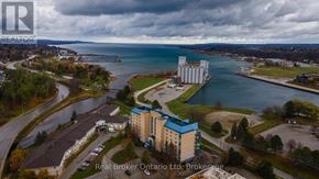 Owen Sound condo for rent - A brokerage office is located in a building with a blue and white exterior.