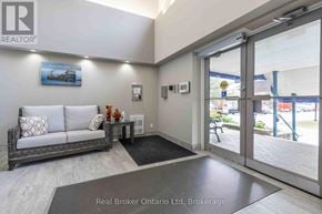 Owen Sound condo for rent - A real estate office with a couch and a painting on the wall.