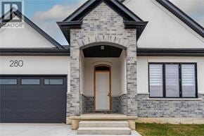Sarnia apartment for rent - A modern house with a stone facade and a wooden door.