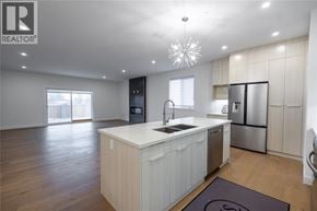 Sarnia apartment for rent - A modern kitchen with a large island and stainless steel appliances.