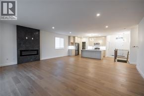 Sarnia apartment for rent - A spacious living room with a fireplace and hardwood floors.