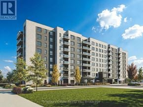 Cambridge condo for rent - A modern apartment building with multiple balconies and a well-maintained lawn in front.