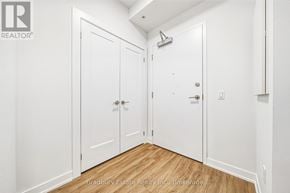 Cambridge condo for rent - A white hallway with two doors and a brokerage sign.