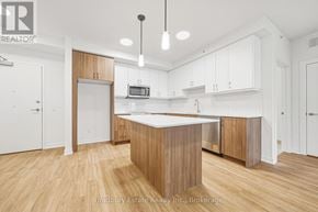 Cambridge condo for rent - A kitchen with wooden floors and white walls.