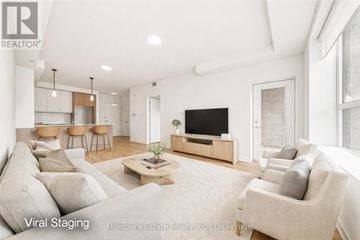 Cambridge condo for rent - A living room with a large couch and a flat screen TV.