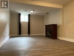 Richmond Hill (Oak Ridges) apartment for rent - A room with a fireplace and a large window.