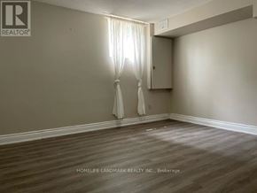Richmond Hill (Oak Ridges) apartment for rent - A room with a window and a curtain.