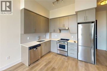 Hamilton condo for rent - A kitchen with a refrigerator, stove, and oven.