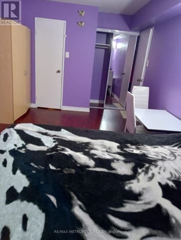 Toronto (Victoria Village) condo for rent - A bedroom with purple walls and a cowhide rug.
