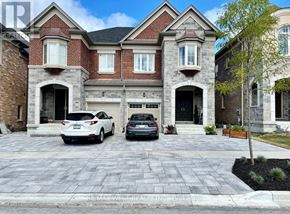 Richmond Hill (Oak Ridges) apartment for rent - A large house with a red brick facade and a driveway with two cars parked in front.