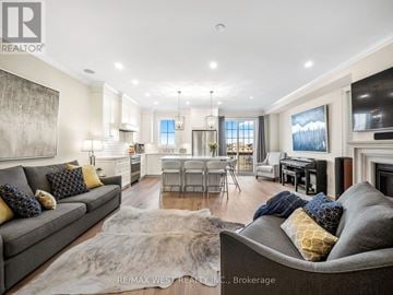 Richmond Hill (Oak Ridges) apartment for rent - A modern living room with a grey couch and a large painting on the wall.