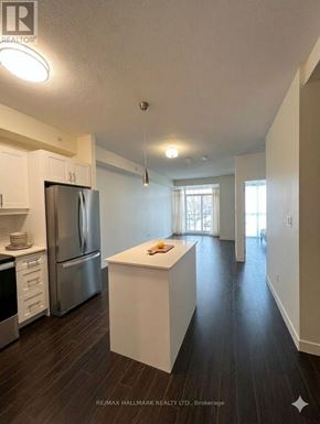 Waterloo condo for rent - A kitchen with white cabinets and a stainless steel refrigerator.