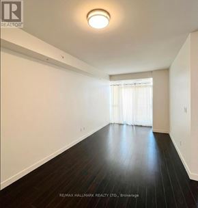 Waterloo condo for rent - A room with wooden floors and white walls.