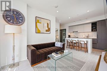Toronto (Waterfront Communities) condo for rent - A living room with a brown couch and a glass coffee table.