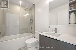 Toronto (Waterfront Communities) condo for rent - A modern bathroom with a glass shower stall and a white toilet.