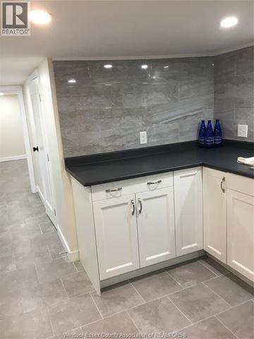 Windsor apartment for rent - A kitchen with white cabinets and a black countertop.