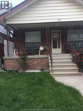 Windsor apartment for rent - A house with a white door and a brick wall.