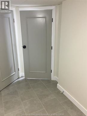 Windsor apartment for rent - A white door is in a hallway with a tiled floor.