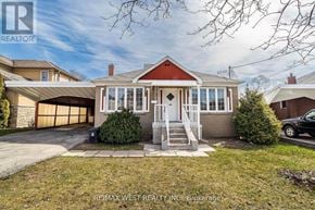 Toronto (Yorkdale-Glen Park) apartment for rent - A house with a red roof and a garage door is for sale.