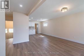 Toronto (Yorkdale-Glen Park) apartment for rent - A spacious room with wooden flooring and white walls, with a light on the ceiling.