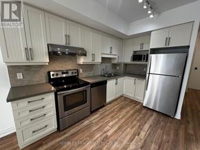 Markham (Unionville) condo for rent - A kitchen with wooden floors and stainless steel appliances.