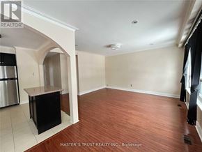 Richmond Hill (Crosby) apartment for rent - A room with wooden flooring and a kitchen area with a fridge and a counter.