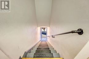 St. Clair apartment for rent - A staircase with a metal handrail leading to a door at the end.