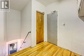 St. Clair apartment for rent - A room with a wooden floor and a door with the number 1 on it.