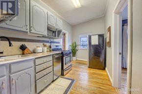 St. Clair apartment for rent - A kitchen with a refrigerator, oven, and sink.