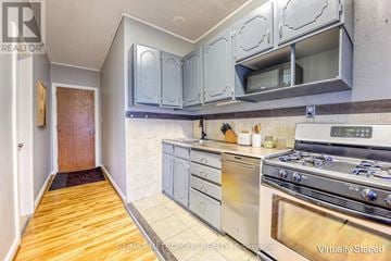 St. Clair apartment for rent - A kitchen with a stove top oven and cabinets above it.