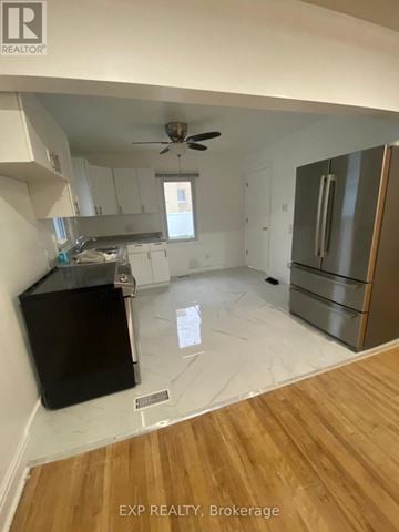 Ottawa apartment for rent - A kitchen with a black counter top and wooden floors.