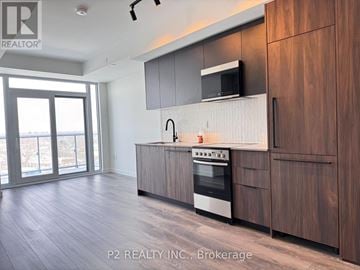 Toronto (Centennial Scarborough) condo for rent - A modern kitchen with wooden cabinets and a stainless steel oven.