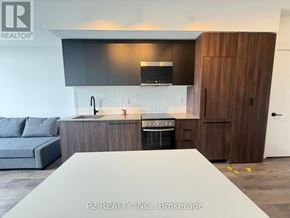 Toronto (Centennial Scarborough) condo for rent - A room with a door and a light on the ceiling.