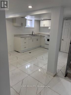 Ottawa apartment for rent - A white kitchen with a sink and cabinets.