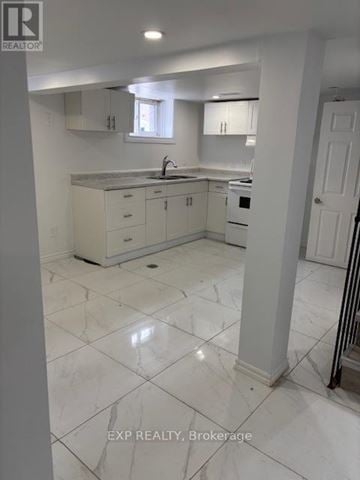 Ottawa apartment for rent - A white kitchen with a sink and cabinets.