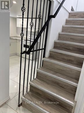 Ottawa apartment for rent - A staircase with a black metal railing and wooden steps.