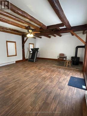 South Glengarry apartment for rent - A room with wooden floors and a ceiling fan.