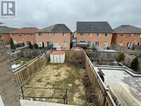 Brampton (Fletcher's Meadow) apartment for rent - A backyard with a wooden fence and a hot tub.