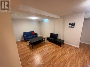 Richmond Hill (Langstaff) townhouse for rent - A living room with a blue couch and a black coffee table.