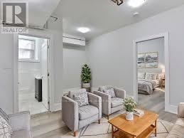 Toronto (Wychwood) multi-family for rent - A living room with a couch, chair, and coffee table.