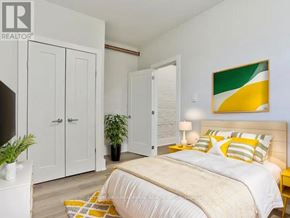 Toronto (Wychwood) multi-family for rent - A bedroom with a bed, two nightstands, and a plant.