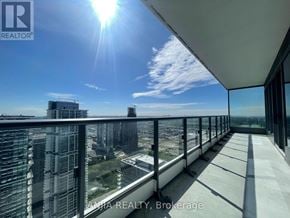Vaughan (Vaughan Corporate Centre) condo for rent - A balcony with a view of a cityscape and the sun shining brightly.