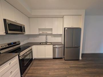 Surrey apartment for rent - A kitchen with white cabinets and stainless steel appliances.
